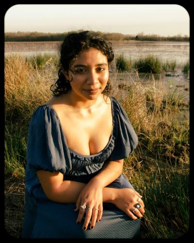 Alina Gomez posing outside